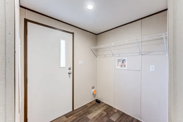 a view of storage and utility room with wooden floor