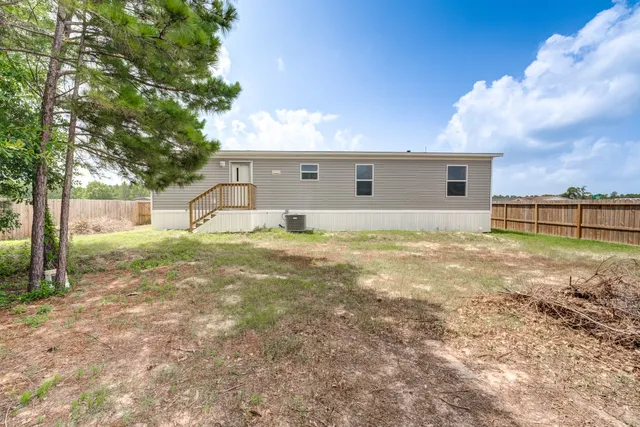 a backyard of a house with yard and tree