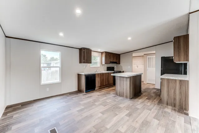 a kitchen with a refrigerator and a stove top oven