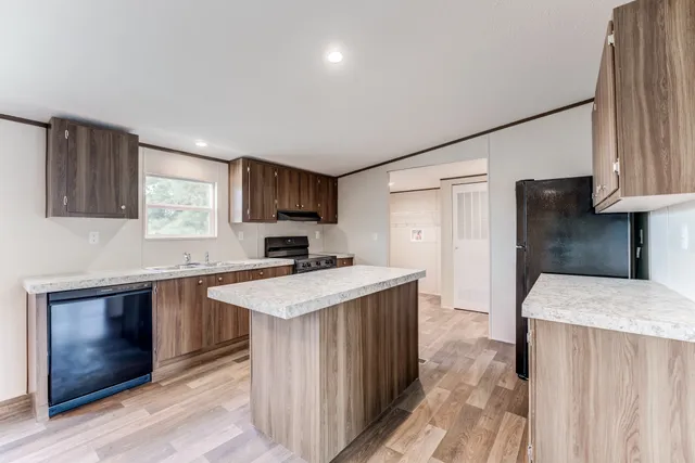 a kitchen with a stove a sink and a refrigerator