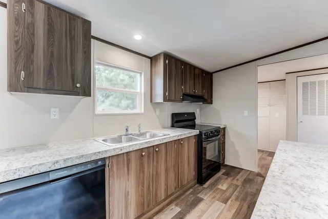 a kitchen with a sink stove and cabinets