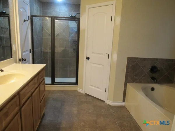 a bathroom with a bathtub and a sink