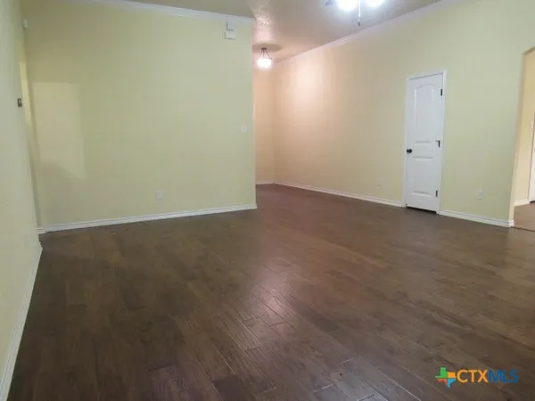 an empty room with wooden floor