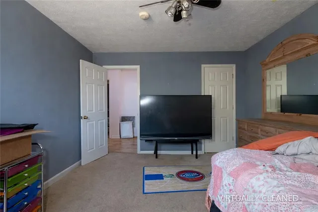 a bedroom with bed and a flat screen tv