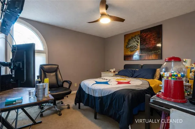 a bedroom with a bed and a chandelier