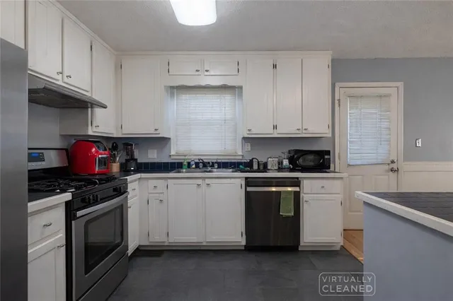 a kitchen with granite countertop cabinets and steel stainless steel appliances