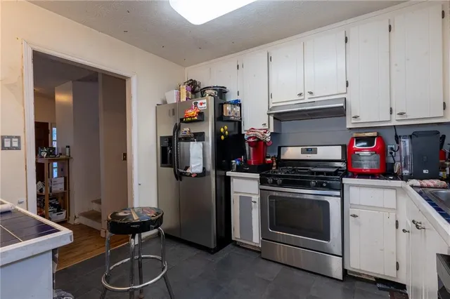 a kitchen with a stove and a refrigerator