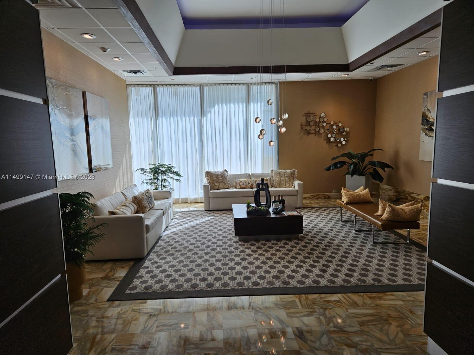 9511 Collins Avenue, Unit 403 Surfside, FL 33154 - Photo 1 of 52 a living room with furniture