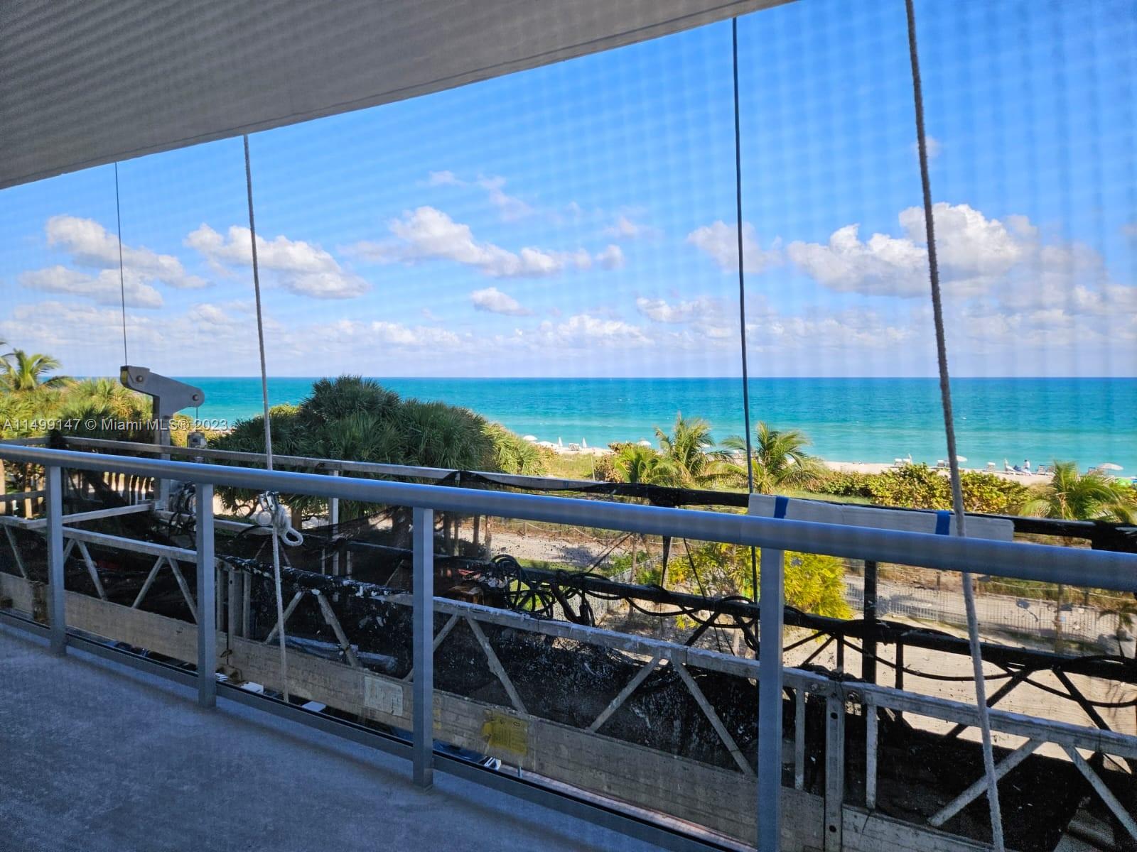 9511 Collins Avenue, Unit 403 Surfside, FL 33154 - Photo 22 of 52 a view of a balcony with chairs and wooden fence