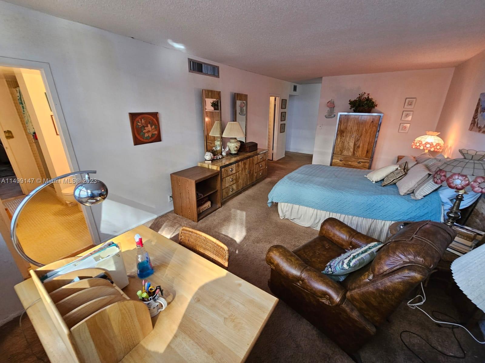 9511 Collins Avenue, Unit 403 Surfside, FL 33154 - Photo 25 of 52 a living room with furniture and wooden floor