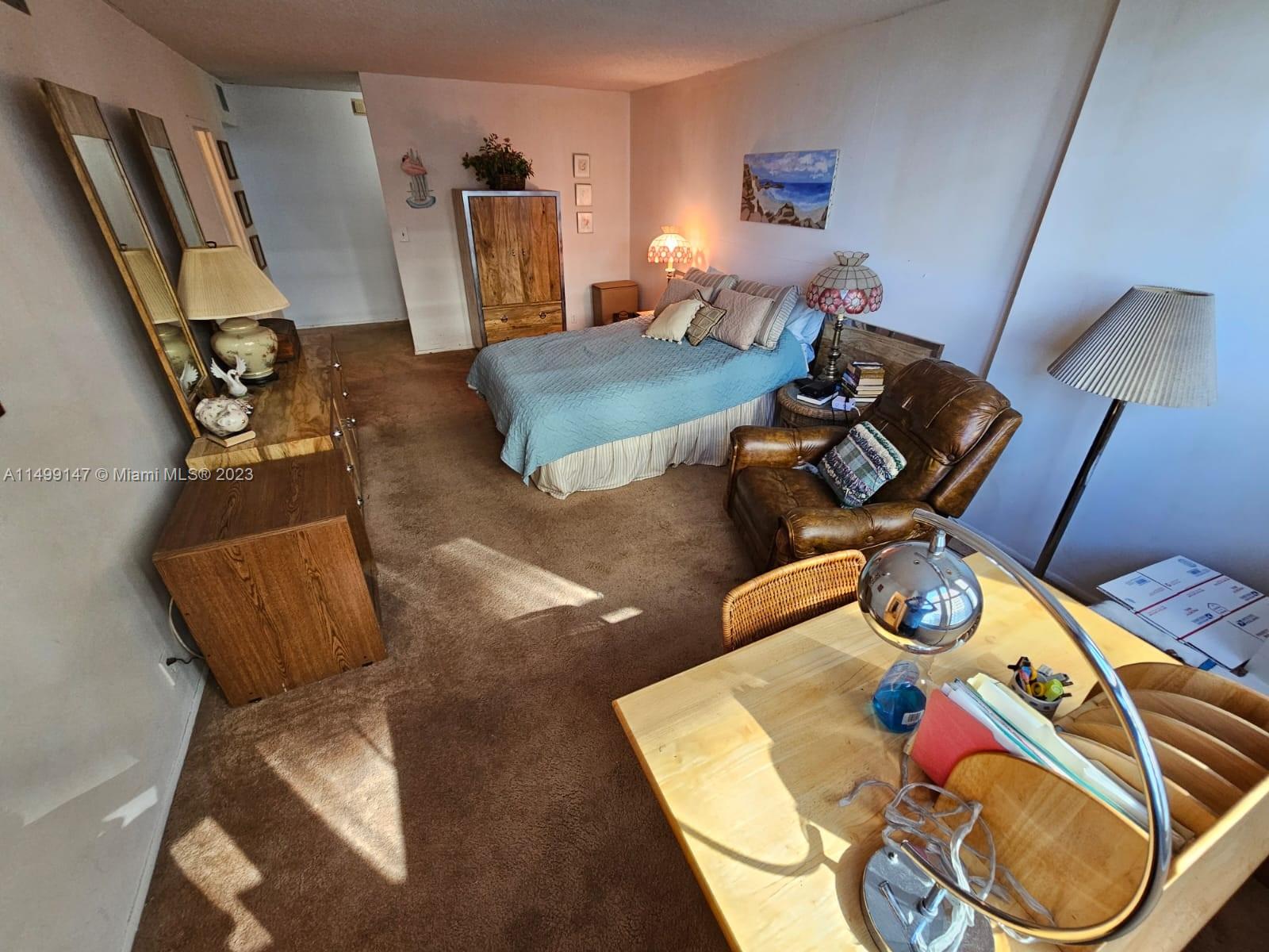 9511 Collins Avenue, Unit 403 Surfside, FL 33154 - Photo 26 of 52 a living room with furniture and a wooden floor