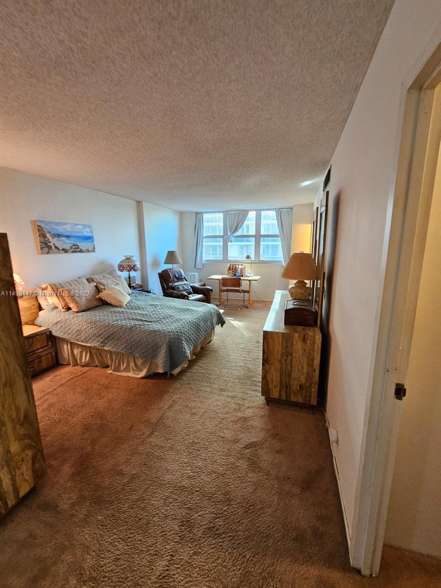 9511 Collins Avenue, Unit 403 Surfside, FL 33154 - Photo 28 of 52 a bedroom with furniture and a window