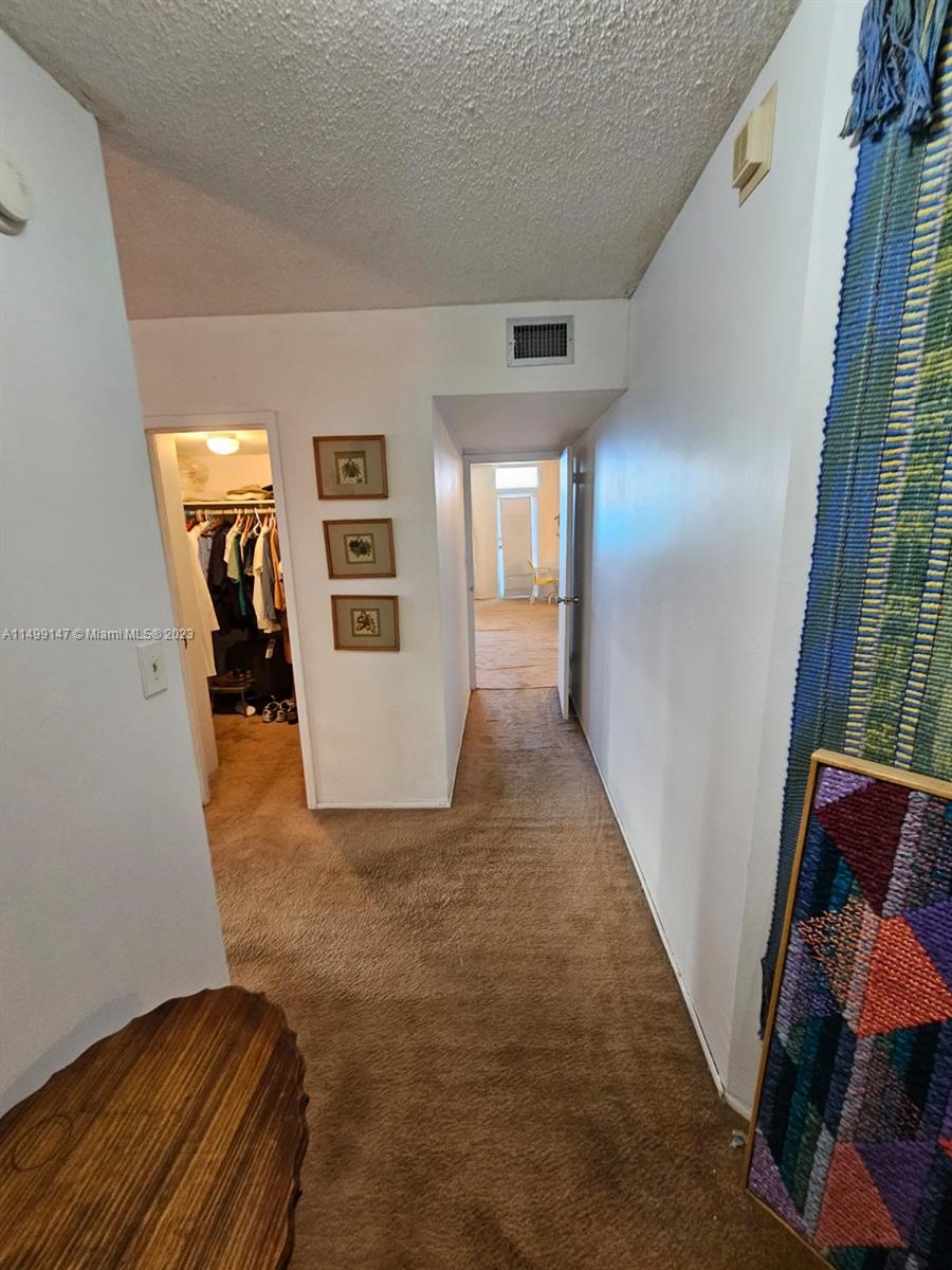 9511 Collins Avenue, Unit 403 Surfside, FL 33154 - Photo 33 of 52 a view of hallway with stairs and wooden floor