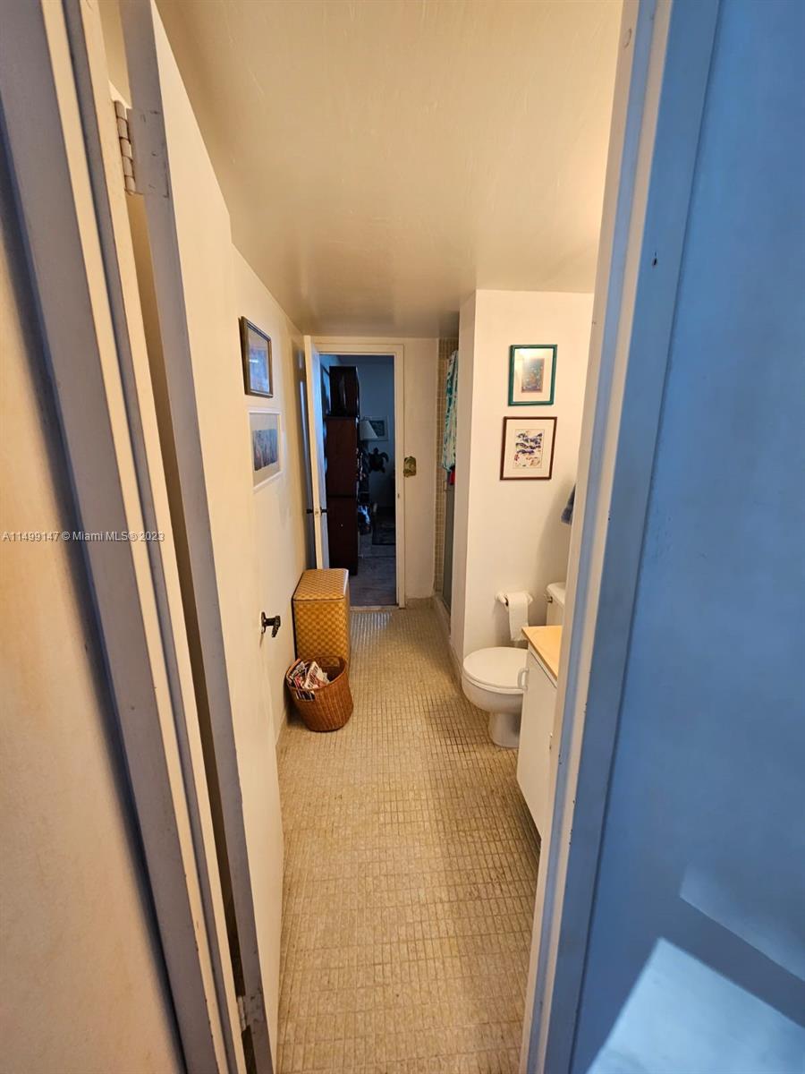 9511 Collins Avenue, Unit 403 Surfside, FL 33154 - Photo 34 of 52 a bathroom with a sink and toilet