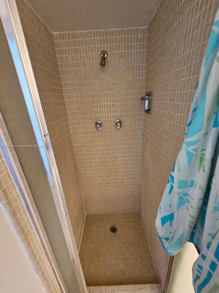 9511 Collins Avenue, Unit 403 Surfside, FL 33154 - Photo 36 of 52 a bathroom with a shower