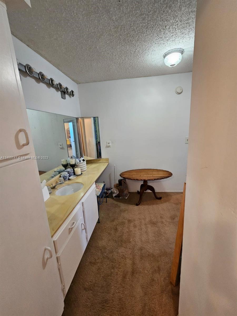 9511 Collins Avenue, Unit 403 Surfside, FL 33154 - Photo 37 of 52 a bathroom with a tub sink and mirror