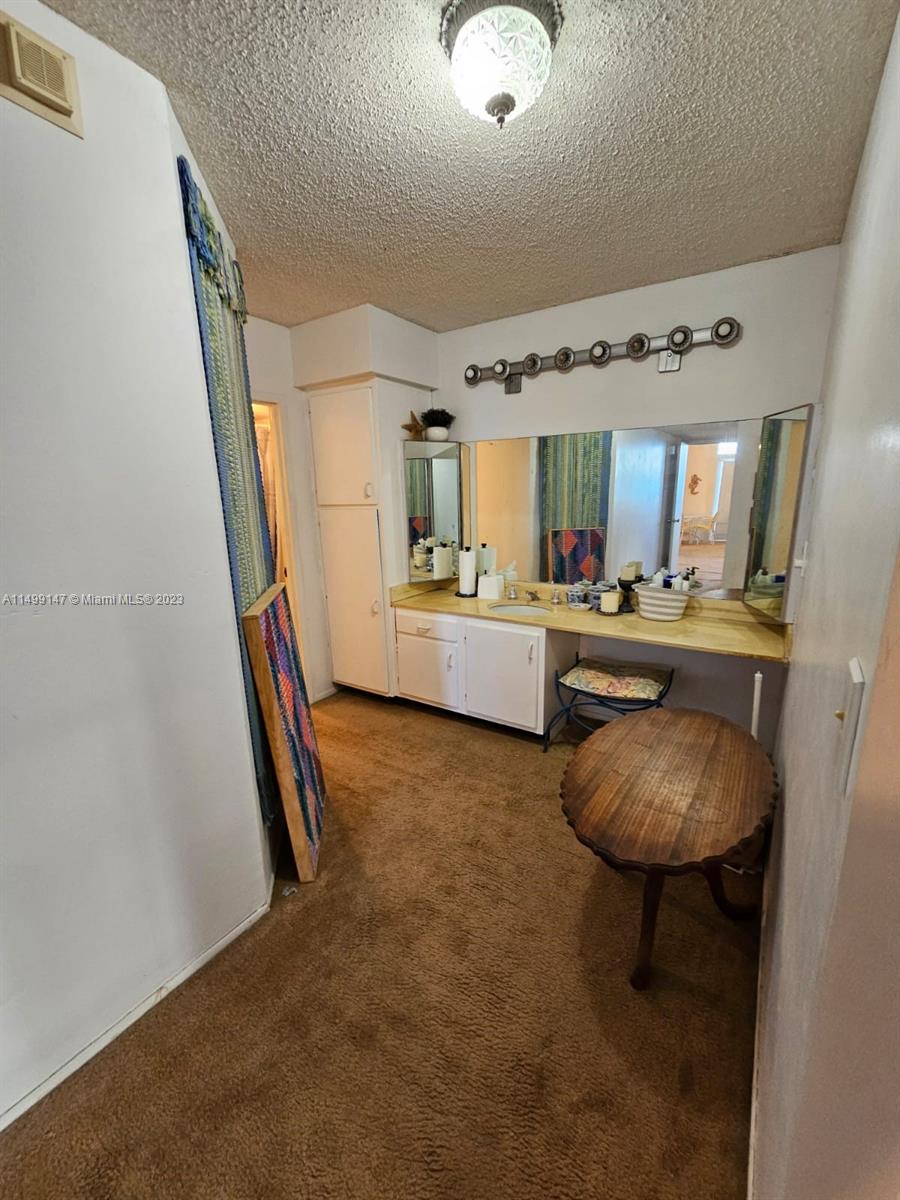 9511 Collins Avenue, Unit 403 Surfside, FL 33154 - Photo 39 of 52 a bedroom with furniture and a wooden floor