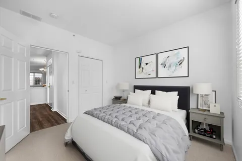 a bedroom with a bed and painting on the wall