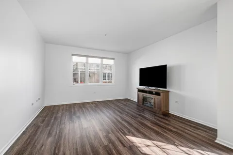 a livingroom with wooden floor and a window