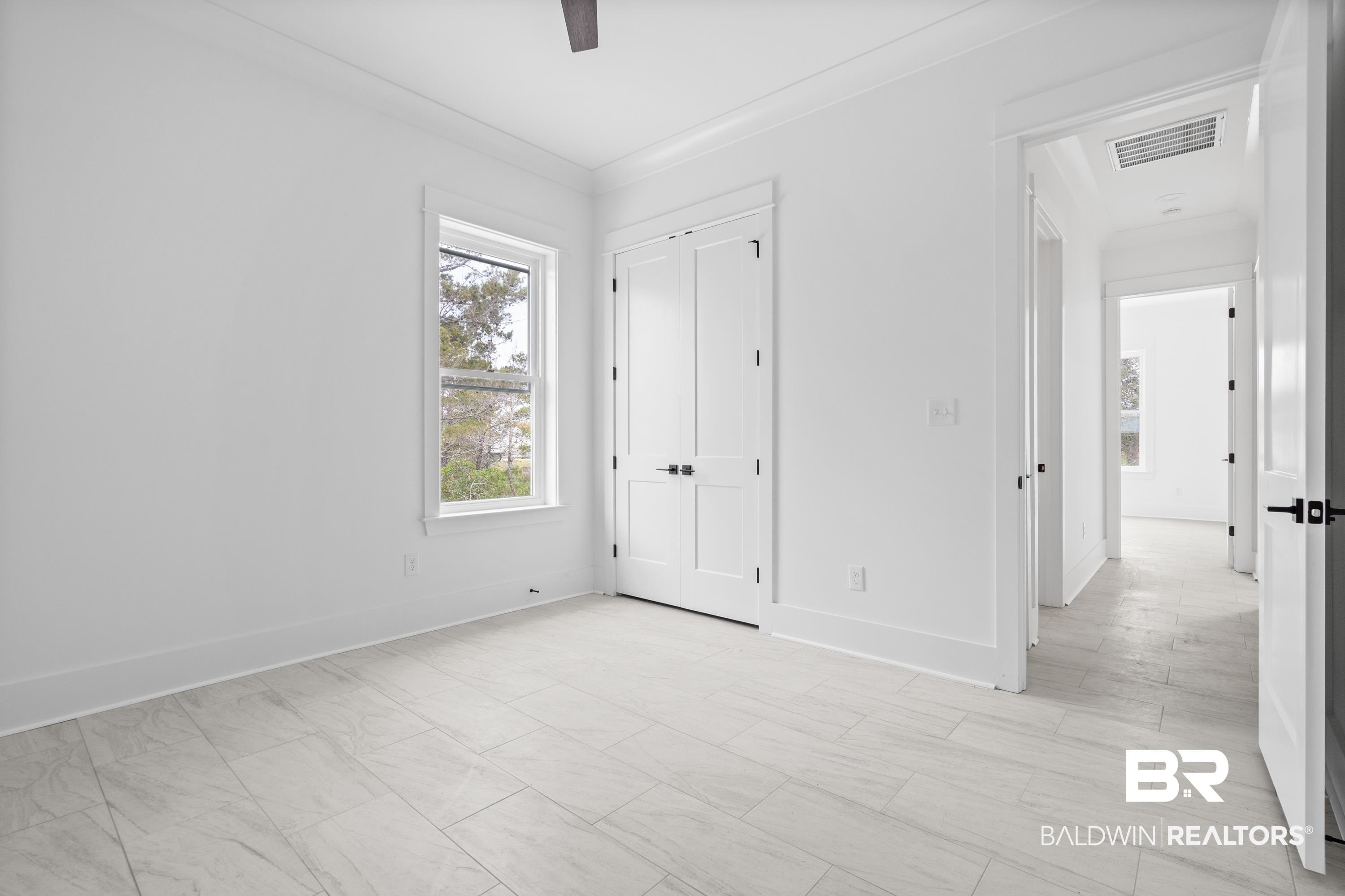 30650 Ono N Loop West Orange Beach, AL 36561 - Photo 25 of 38 Unfurnished bedroom with baseboards, ceiling fan, and a closet