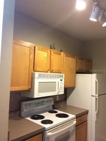 a stove top oven sitting inside of a kitchen