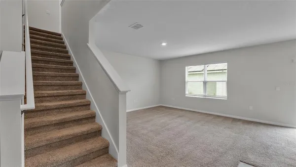 a view of an empty room with stairs