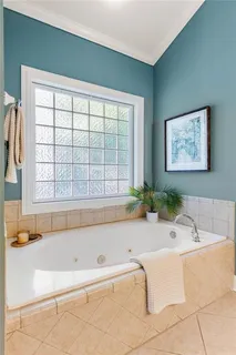 a bath tub sitting in a bathroom next to a window