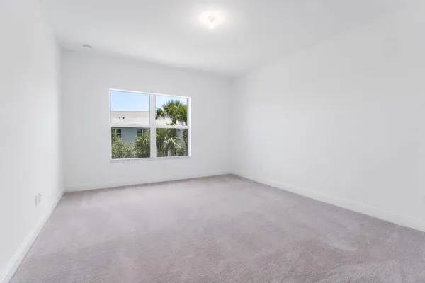 a view of empty room with white walls