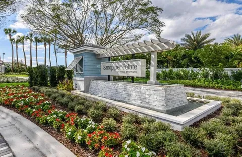 a front view of a house with a yard and fountain