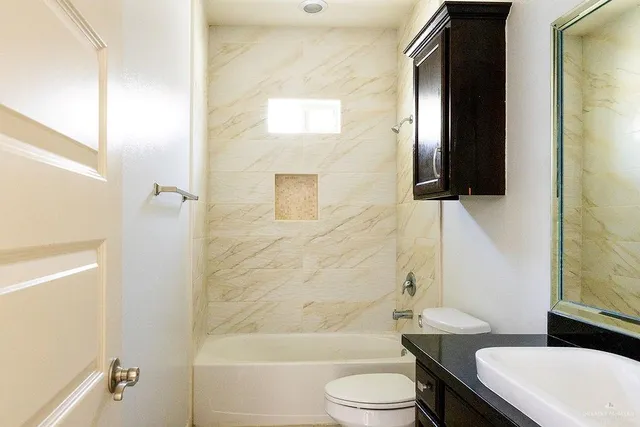 a bathroom with a toilet a sink and bathtub