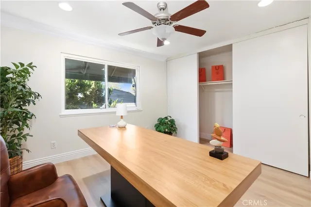 a view of a workspace with furniture and a potted plant