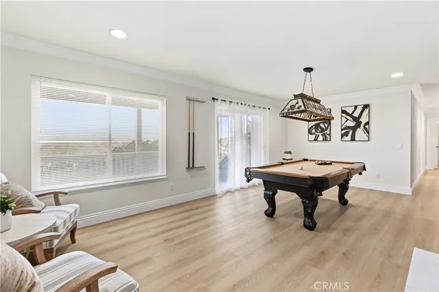 a room with furniture a chandelier and wooden floor