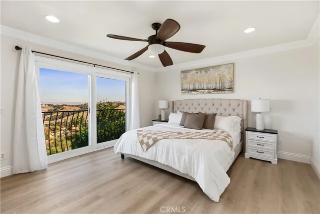 a spacious bedroom with a large bed and a large window