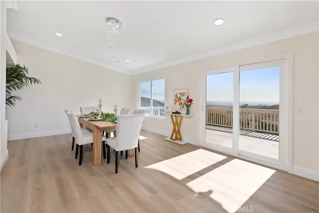 a dining room with furniture and a potted plant