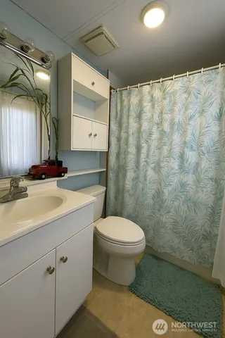 a bathroom with a sink a toilet and a shower