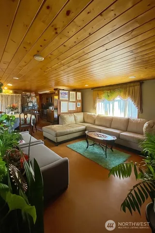 a living room with patio furniture and a wooden floor