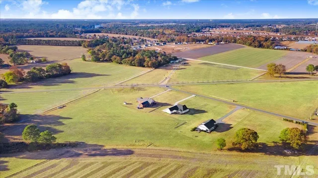 an empty room with windows a fireplace and wooden floor