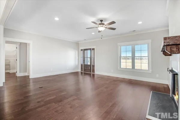 a kitchen with stainless steel appliances kitchen island granite countertop a refrigerator a stove a microwave and a wooden floors
