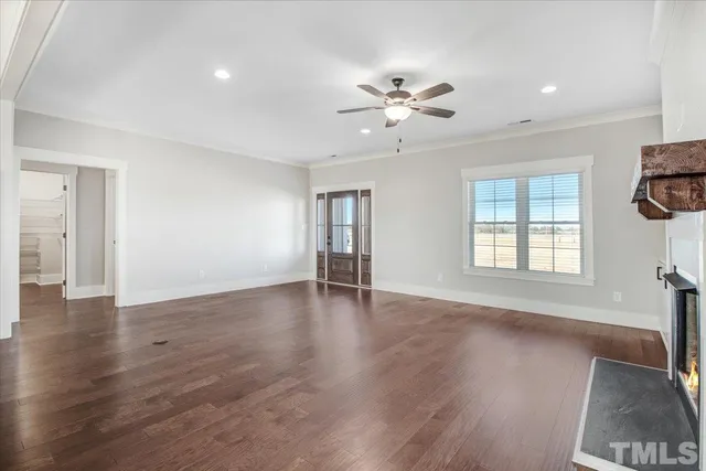 a kitchen with stainless steel appliances kitchen island granite countertop a refrigerator a stove a microwave and a wooden floors