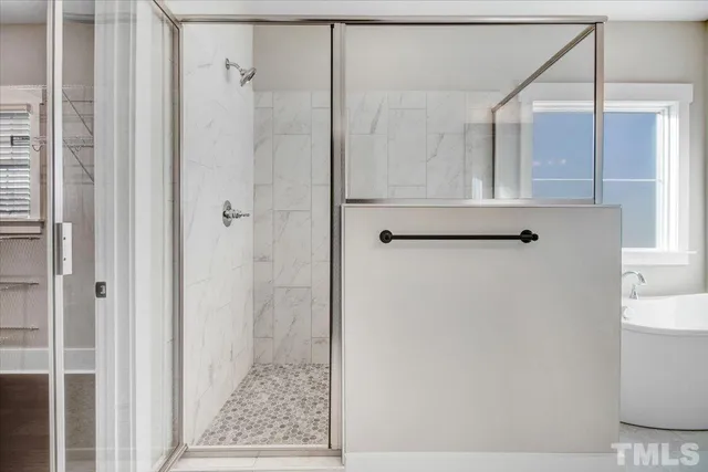 a bathroom with a bathtub and shower