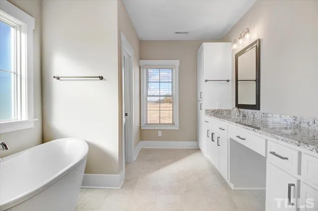 a bathroom with double sink and a mirror