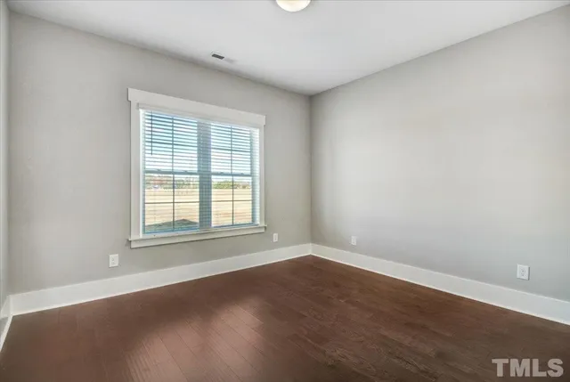 a bathroom with a granite countertop toilet a sink and mirror