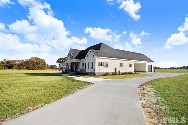 a front view of a house with a big yard