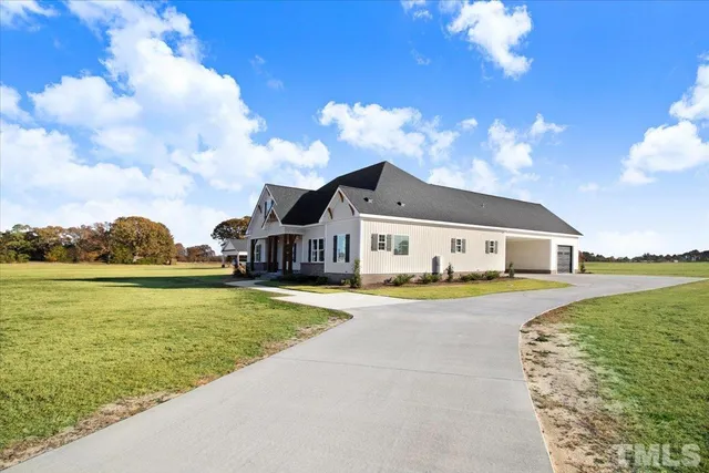 a front view of a house with a big yard