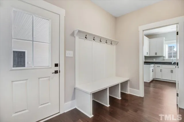 a kitchen with white cabinets and white appliances