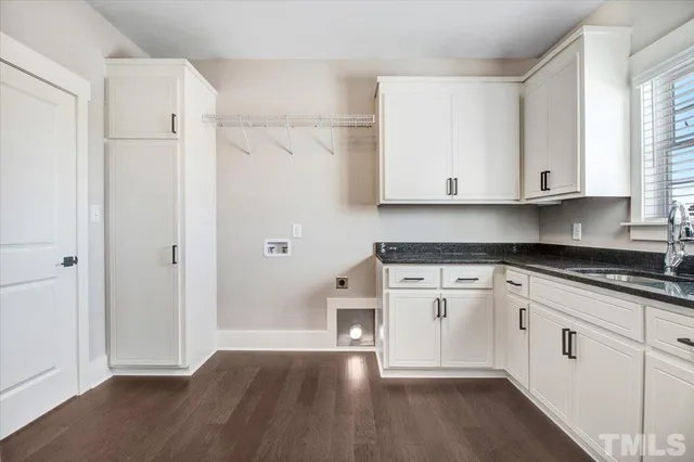 a kitchen with granite countertop white cabinets and white appliances