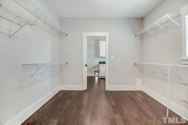 a bathroom with a granite countertop toilet sink and mirror