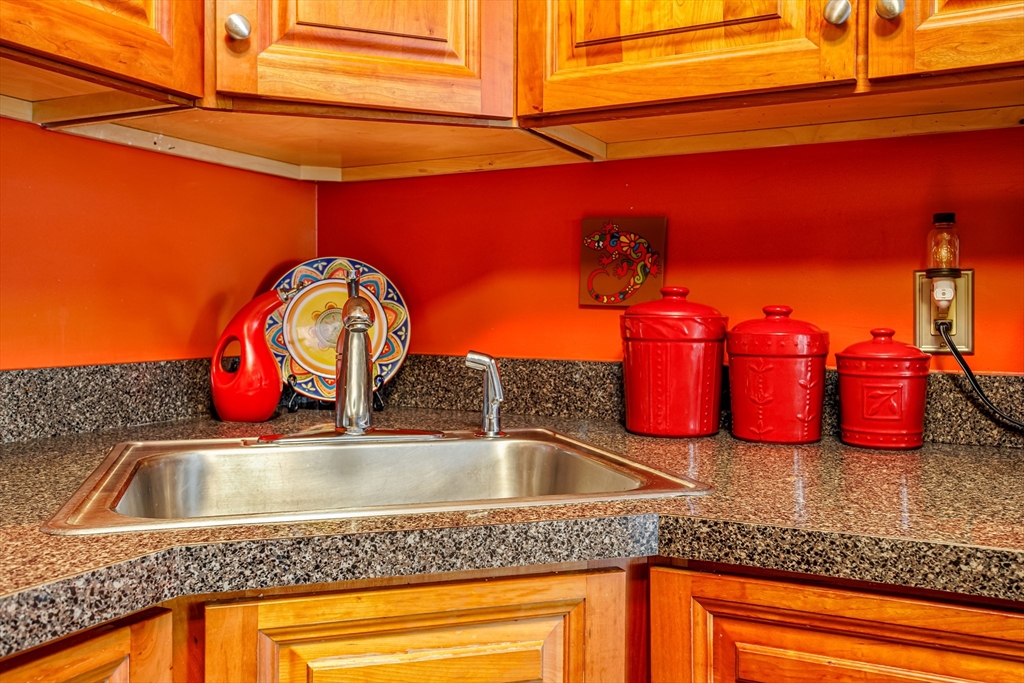 101 Bridle Cross Road, Unit 101 Fitchburg, MA 01420 - Photo 14 of 26 a kitchen with stainless steel appliances granite countertop a sink and a wooden cabinets