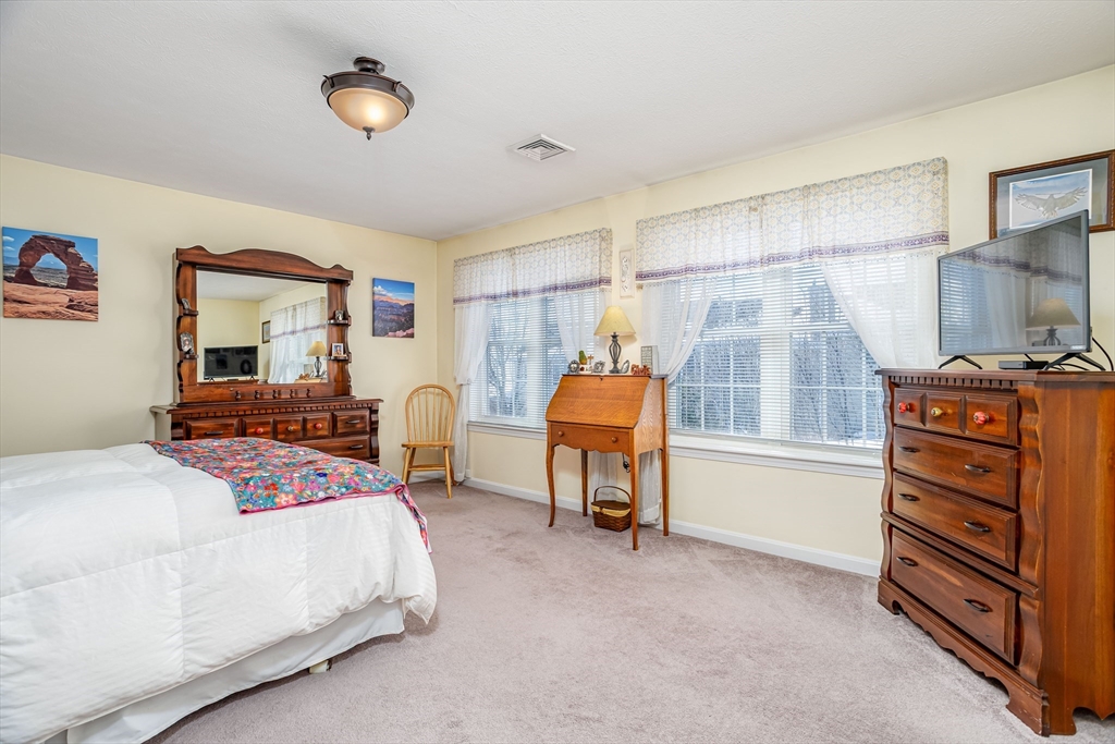 101 Bridle Cross Road, Unit 101 Fitchburg, MA 01420 - Photo 15 of 26 a bedroom with a bed and a cabinets