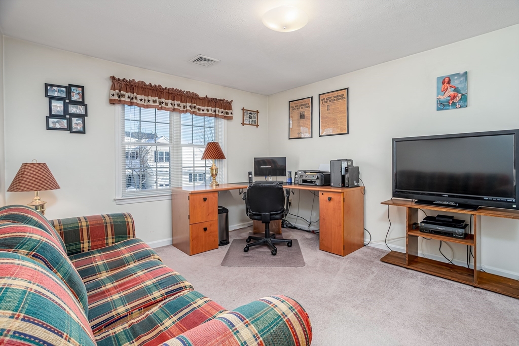 101 Bridle Cross Road, Unit 101 Fitchburg, MA 01420 - Photo 19 of 26 a bedroom with furniture and a flat screen tv